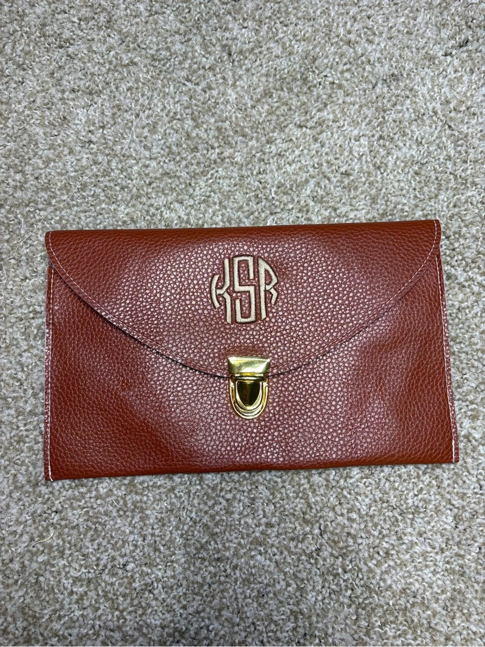 Monogram Convertible Clutch in Rust Brown